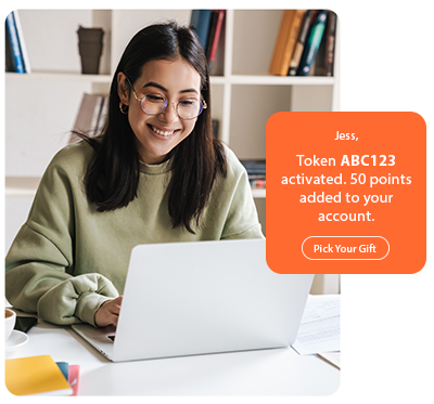 Woman smiling at laptop as a corporate gifting solution adds 50 points and prompts her to pick a gift. Woman smiling at laptop as a corporate gifting solution adds 50 points and prompts her to pick a gift.